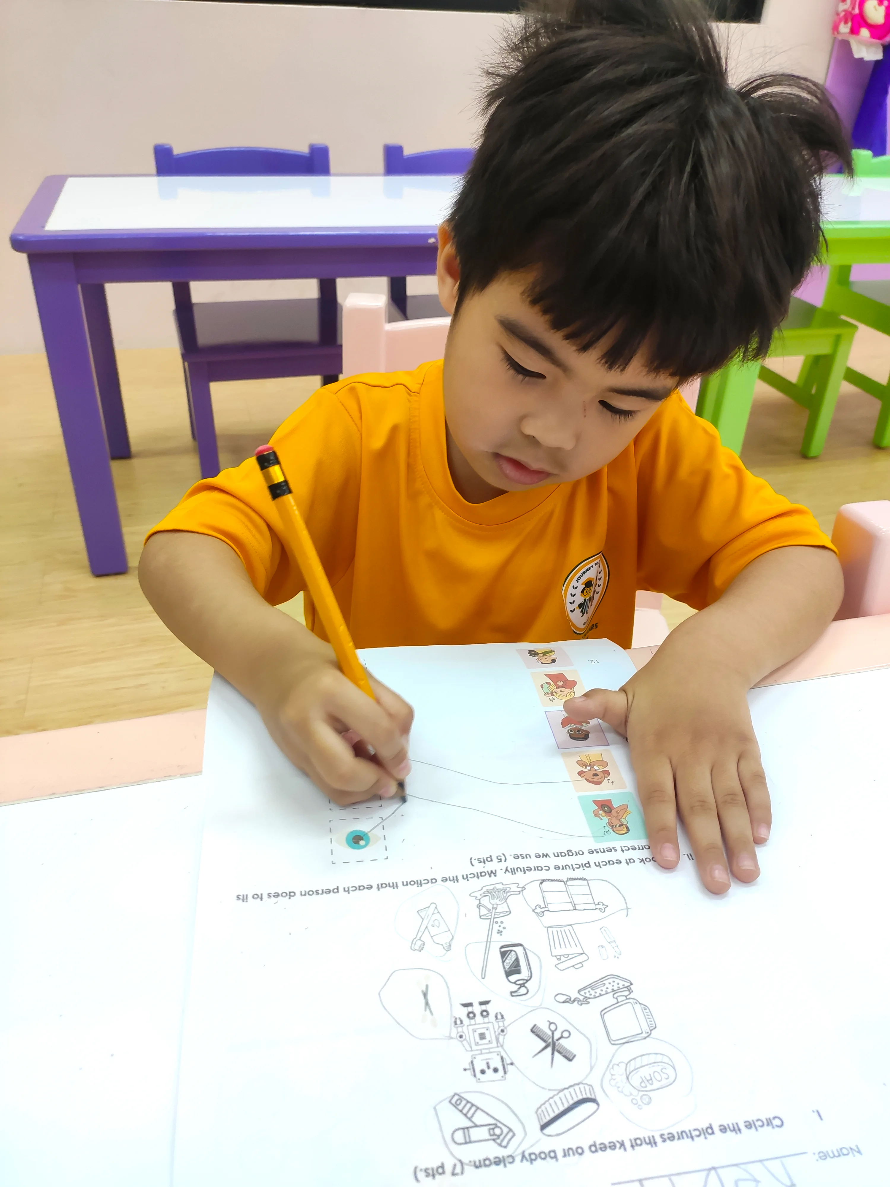 Senior Nursery learner completing a classroom worksheet